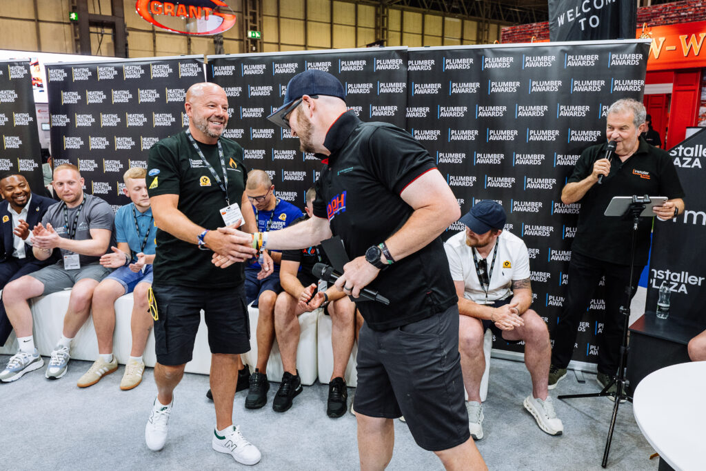 Steve Gray shakes hands with Pointy the Plumber (Robert Clark) at the Plumber Awards 2026